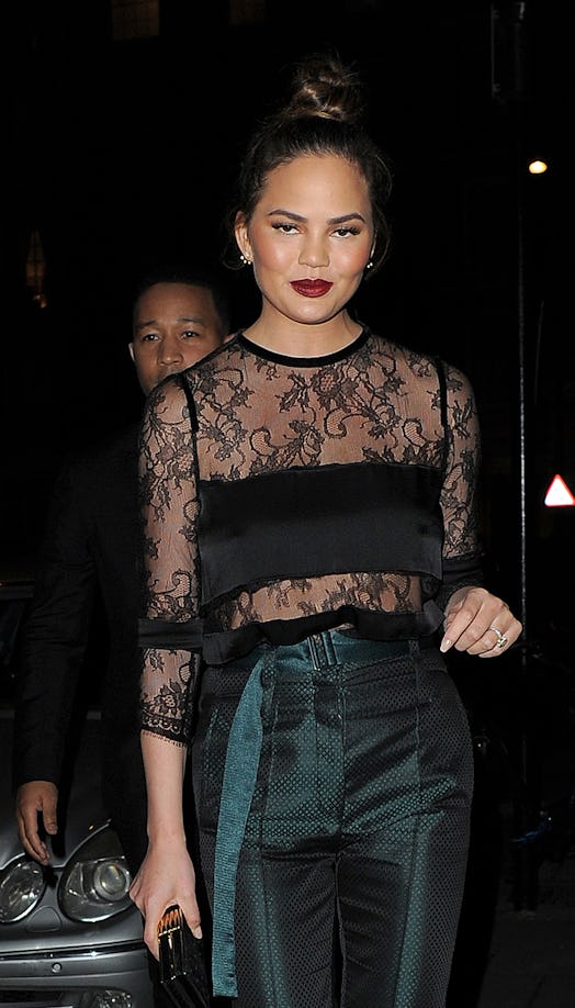 Chrissy Teigen, shown here walking down a street at night, is supported by her husband John Legend i...