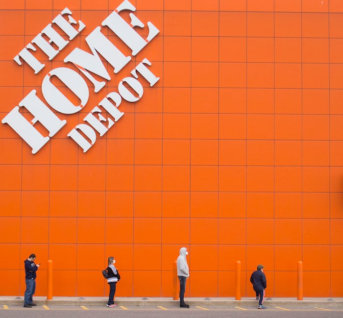 TORONTO, April 3, 2020 -- People line up with a social distance to enter a Home Depot store in Toron...