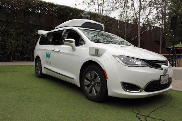 A Waymo self-driving car pulls into a parking lot at the Google-owned company's headquarters in Moun...