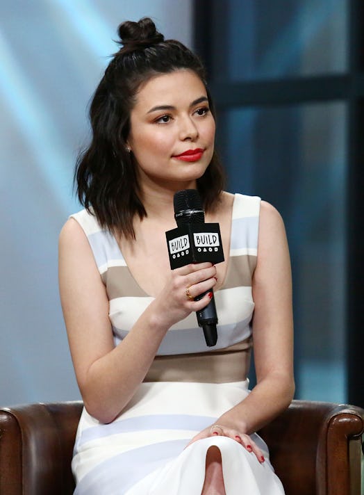 Miranda Cosgrove, shown here being interviewed in 2017, said growing up on TV was "challenging." 