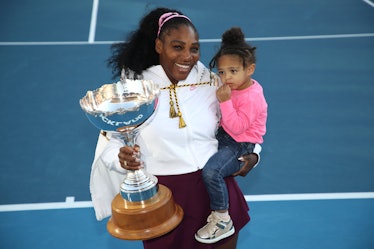erena Williams of the USA holds her daughter Alexis Olympia with the trophy following the Women's Fi...
