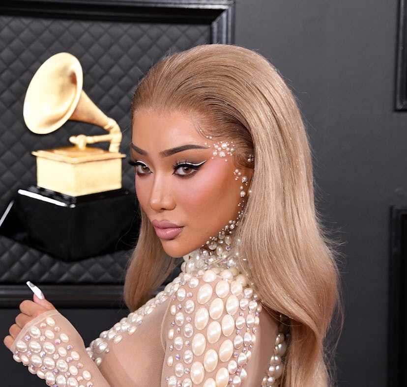 Nikita Dragun, founder of Dragun Beauty, poses on the red carpet at the 2021 Grammy Awards