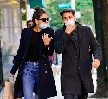 Katie Holmes in a black shirt, coat and blue denim jeansm and Emilio Vitolo Jr. in a grey shirt and ...