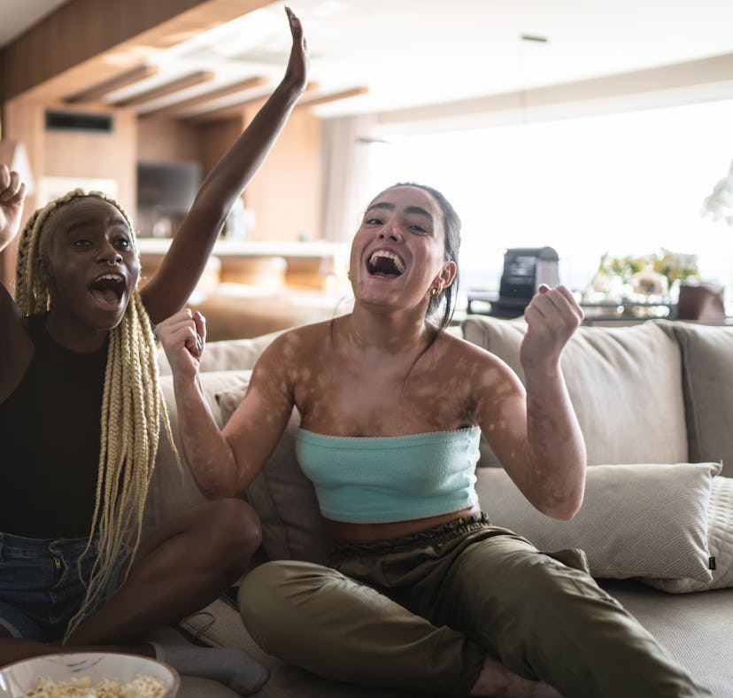 Friends together watching the 2021 Olympics on television at home together might need captions to ca...