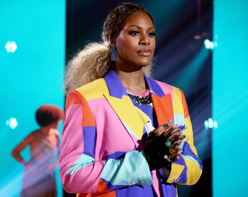 Laverne Cox in a multicolored blazer shares body positive quotes.