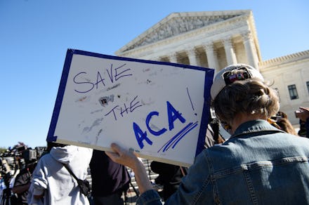 A demonstrator holds a sign in front of the US Supreme Court in Washington, DC, on November 10, 2020...
