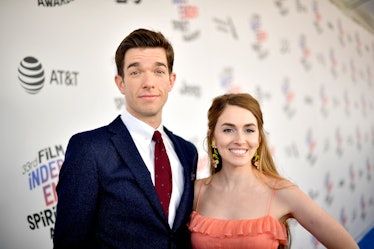 John Mulvaney in a navy suit, white shirt and a red tie and Anna Marie Tendler in an orange dress