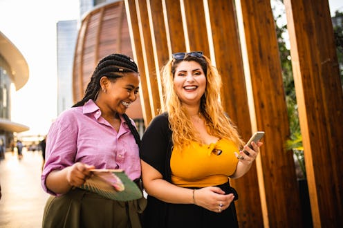 Two women walk in the city, proud to have found body positivity, neutrality, and acceptance. What's ...