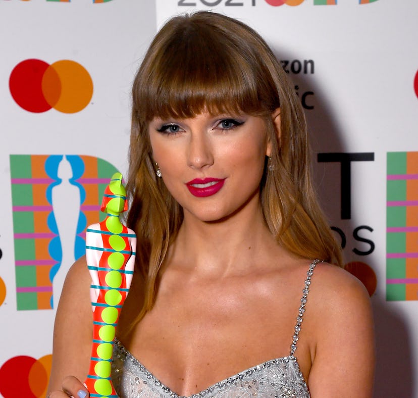 LONDON, ENGLAND - MAY 11: Taylor Swift poses backstage with the award for Global Icon during The BRI...