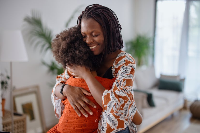 A mother hugging her daughter after explaining Juneteenth to her