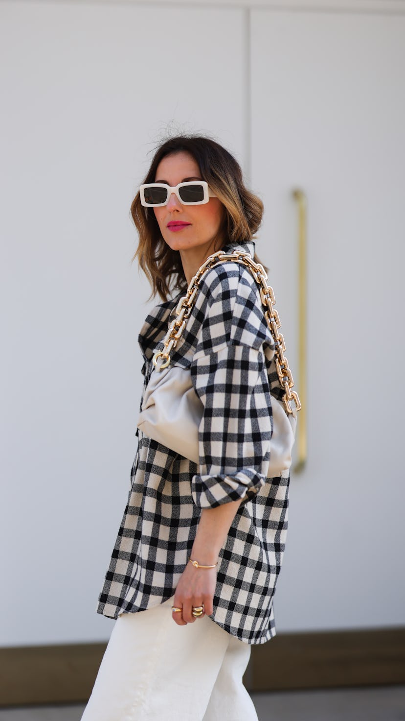 Elise Soho walking in the street and wearing a black and white Checkerboard Shirt