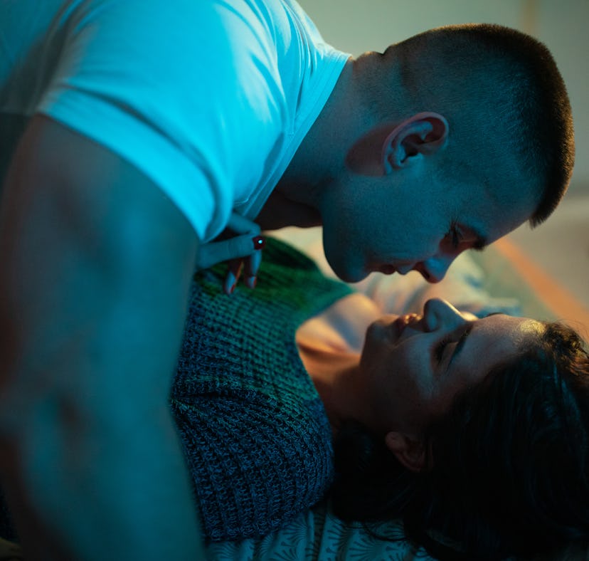 Young couple spending morning in bed, cuddling and kissing