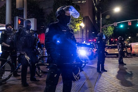 PORTLAND, OR - APRIL 20: Portland police stand guard as tensions rise with a small group of proteste...