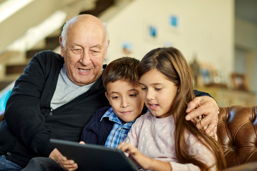 kids and their grandfather looking at a tablet together, father's day quotes in spanish