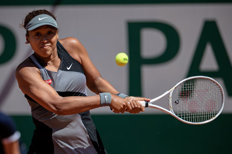 Osaka Naomi of Japan returns the ball during the women's singles first round match against Patricia ...