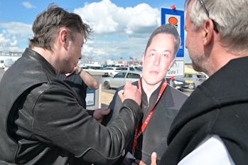 17 May 2021, Brandenburg, Grünheide: Elon Musk (l), Tesla CEO, stands on the construction site of th...