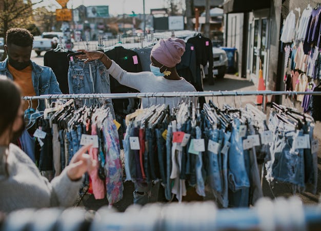 A cheerful multi-ethnic group of young adults window shop on a sunny street in Portland, Oregon, wea...