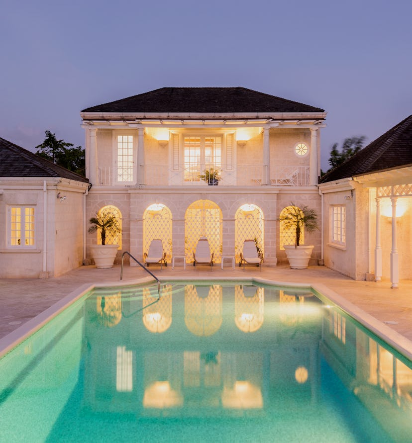 a white villa with a geometric pool