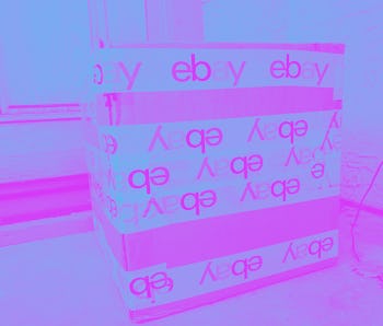 Photograph of a large cardboard shipping box secured with packing tape featuring the eBay logo on a ...