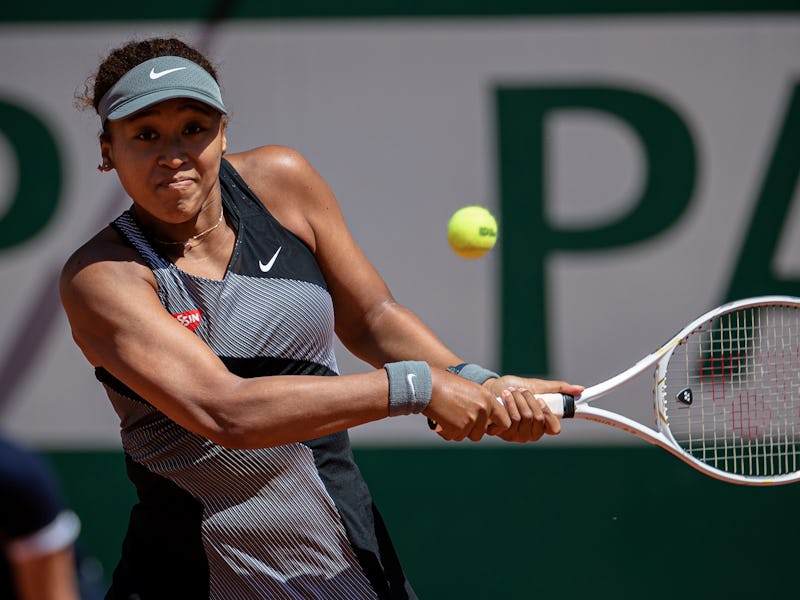 Osaka Naomi of Japan returns the ball during the women's singles first round match against Patricia ...