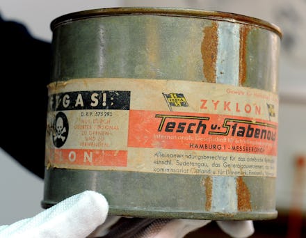 An archive employee holds a can of Zyklon B poison gas at the former Inspectorate of the Concentrati...