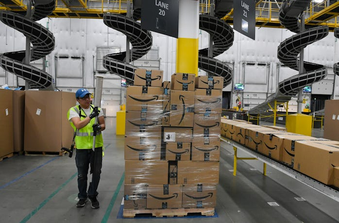 THORNTON, CO - FEBRUARY 19: Billie Her, a warehouse associate, wraps plastic around a pallet of boxe...