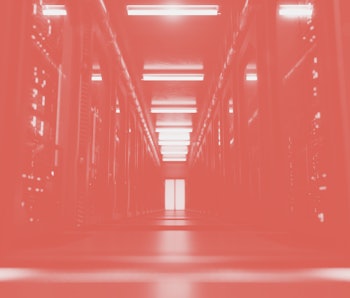 A large hallway with supercomputers inside a server room data center. Technology used for cloud comp...
