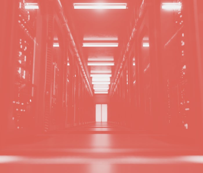 A large hallway with supercomputers inside a server room data center. Technology used for cloud comp...