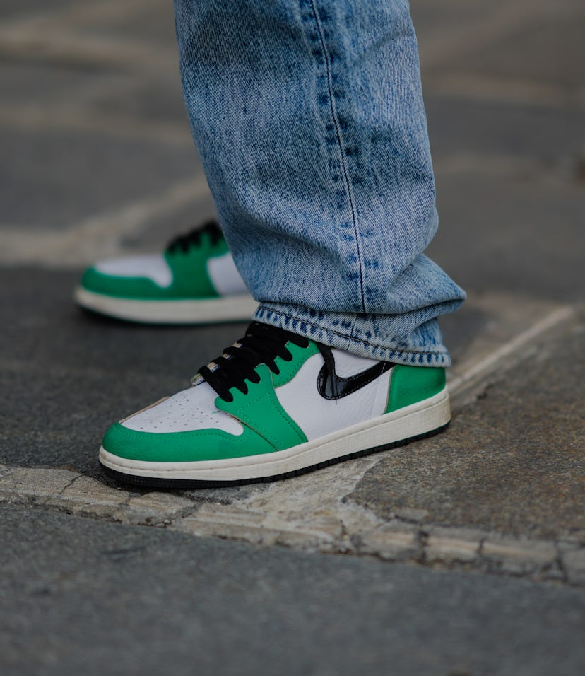 PARIS, FRANCE - APRIL 29: Tamara Kalinic wears blue faded denim boyfriend jeans Ksubi pants, white a...