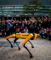 People take pictures and videos of Boston Dynamics Robot Dog named "Spot" during a presentation on t...