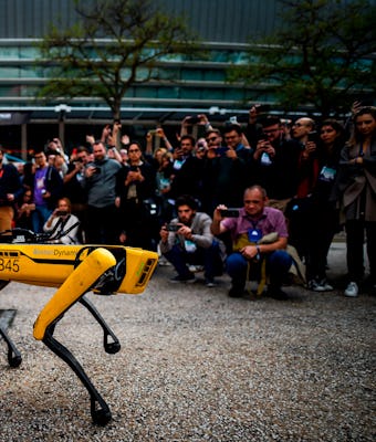 People take pictures and videos of Boston Dynamics Robot Dog named "Spot" during a presentation on t...