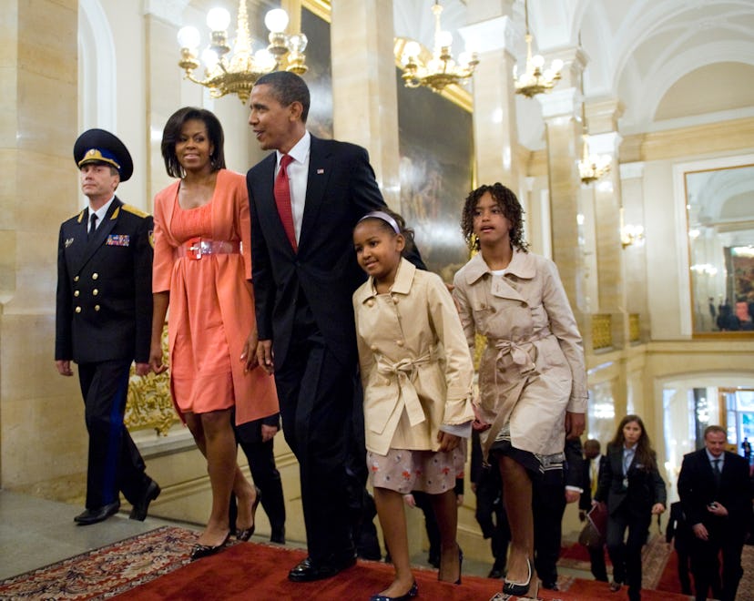 US President Barack Obama, his wife Michelle and their daughters Sasha and Malia walk through the Kr...