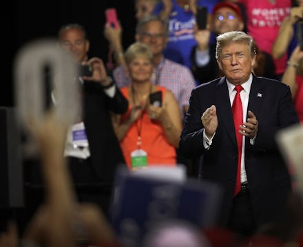 TAMPA, FL - JULY 31:  A sign in the shape of a Q is held up as President Donald Trump attends his Ma...