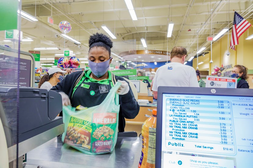 Florida, Miami Beach, Publix, supermarket check out cashier during Coronavirus Pandemic. On May 27, ...