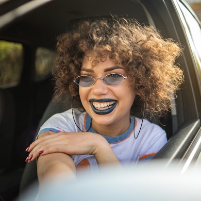 Young woman with blue lipstick having the best week of June 21, 2021, per her zodiac sign.