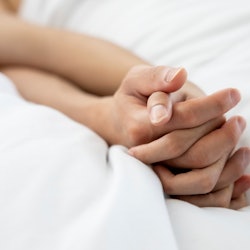 Love emotion concept:  hand of couple love on the white bed