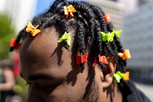 Demetrius Ervin decorates his hair with butterfly clips in remembrance of MaKhia Bryant during a ral...