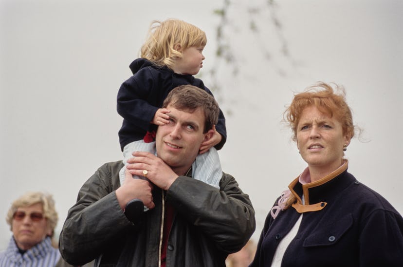 British Royal Princess Beatrice sits on the shoulders of her father, Prince Andrew, Duke of York, al...