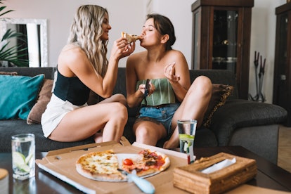 Woman who has had a sex dream about her best friend feeds her pizza.