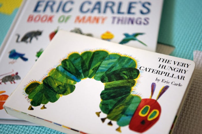 This photo illustration taken on May 26, 2021 shows Eric Carle's "The Very Hungry Caterpillar" and "...