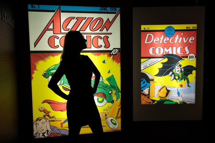 LONDON, ENGLAND - FEBRUARY 22: An employee poses in front illuminated displays of the first comics t...