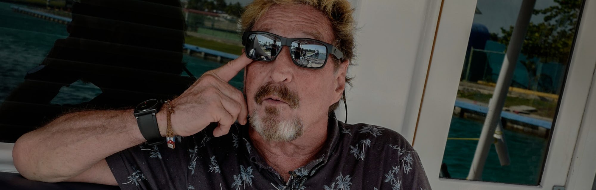 US millionaire John McAfee gestures during an interview with AFP on his yacht anchored at the Marina...