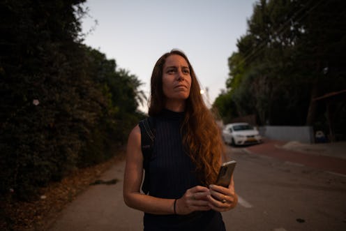 woman walking and holding her phone