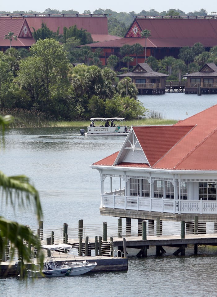 A boat belonging to the Orange County Sheriff's office searches the Seven Seas lagoon between Disney...