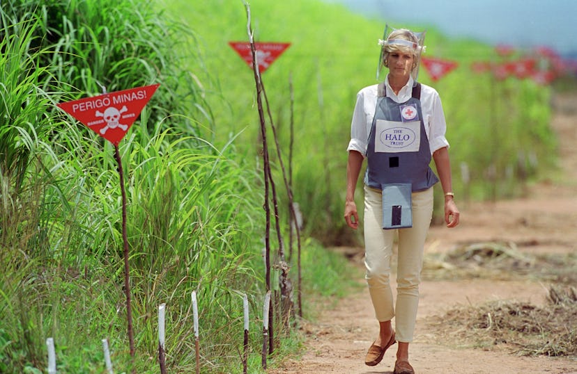 Diana, Princess of Wales wearing protective body armour and a visor visits a landmine minefield bein...