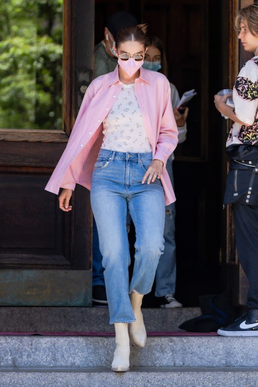 Gigi Hadid wears tank top and jeans from the recent H&M x Brock Collection collab while grabbing ice...