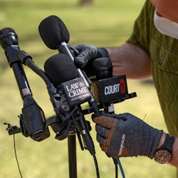 A man readies a microphone in Minneapolis after April's ruling on Derek Chauvin's murder charges.