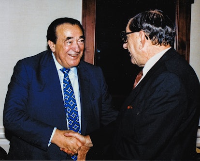 Ghislaine Maxwell's father Robert Maxwell shakes hands with the South African Ambassador to the Unit...