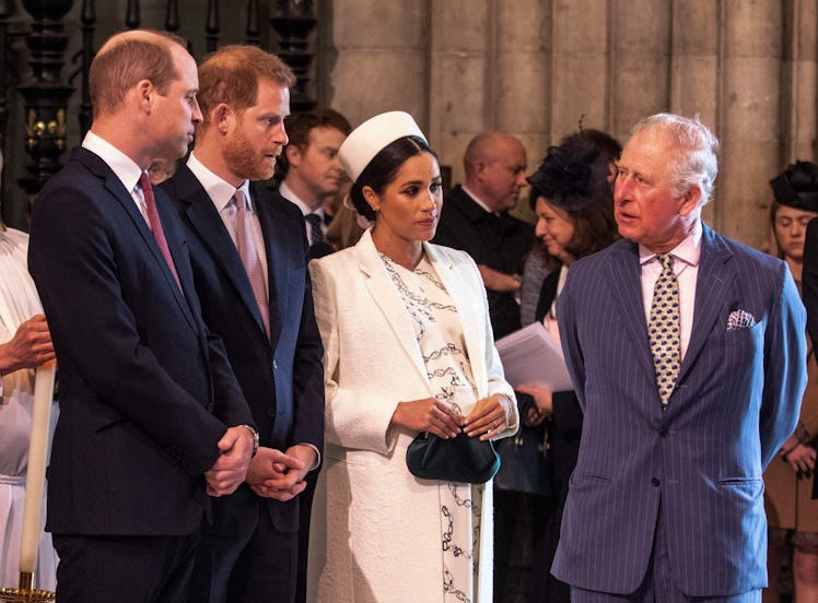 Britain's Meghan, Duchess of Sussex (2R) talks with Britain's Prince Charles, Prince of Wales (R) as...