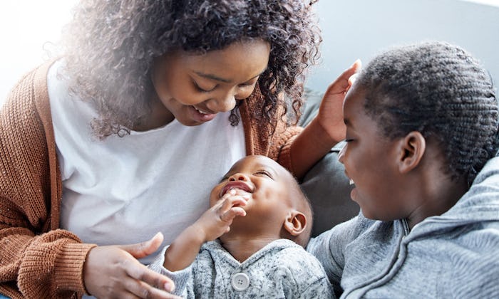 mom and two kids laughing